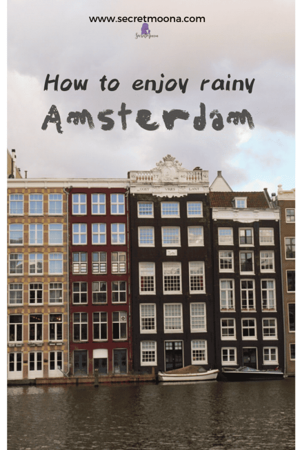 Pinterest graphic reading 'How to enjoy rainy Amsterdam' over a row of canal houses on the Damrak