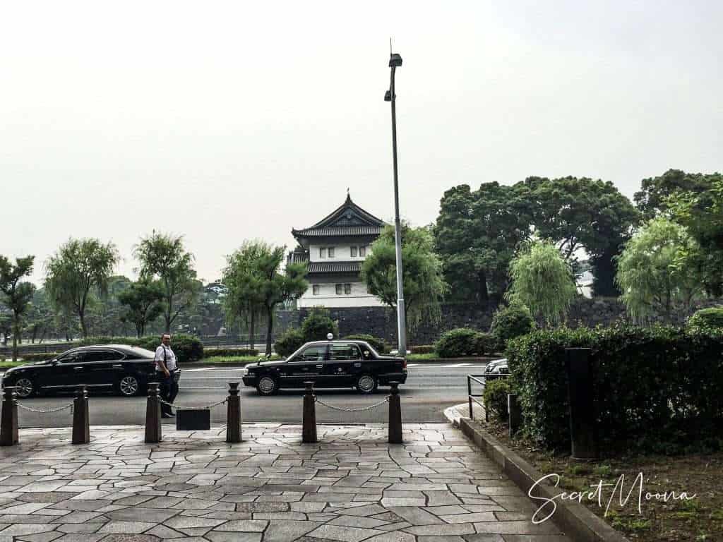 View of the Imperial Palace with two black taxi passing through, Tokyo