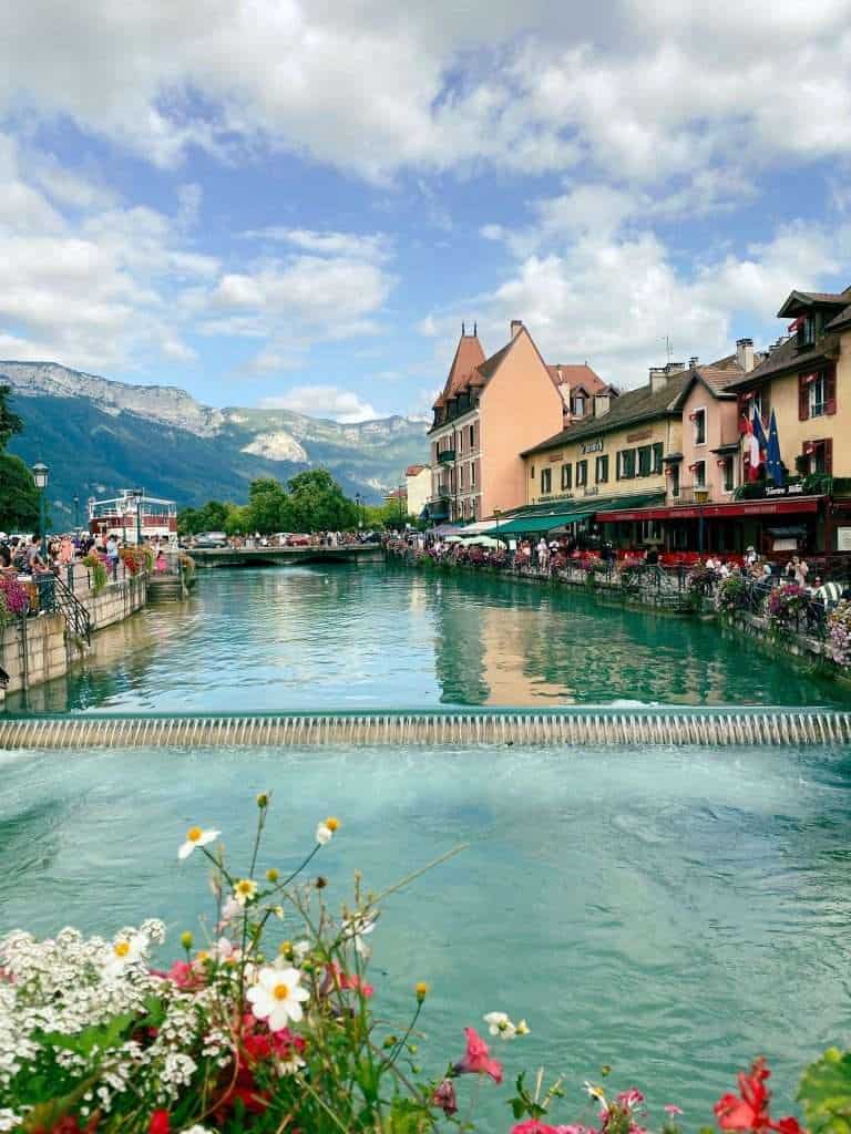 Amazing Things to do in and around Lake Annecy, France 8 Charming Thiou canal with mountains as backdrop