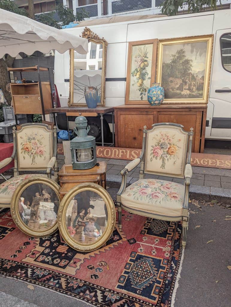 Old portraits and chair on display at La Grande Braderie de Lille - Weekend Lille