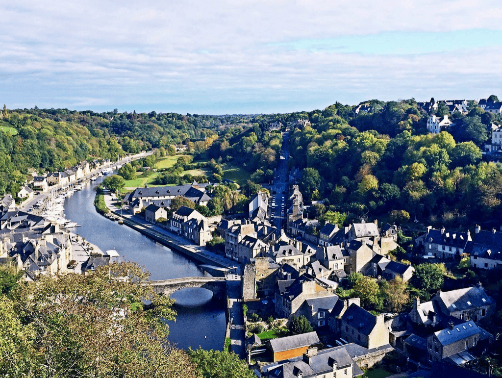 Things To Do In Brittany, France: A Journey Through Scenic Landscapes, And Authentic Culture. 18 Breathtaking view of Dinan, a town in Brittany, France, from atop a hill, showcasing a picturesque river.