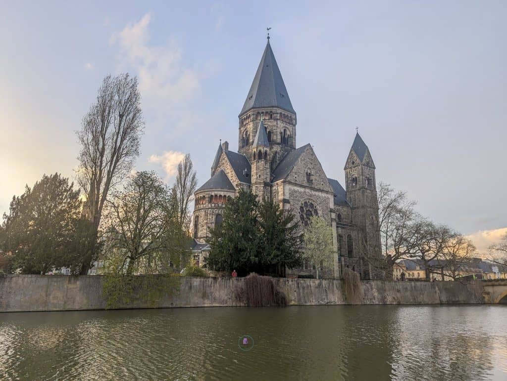Discover The Best Things To Do In Metz, France 13 Temple Neuf church in front of a body of water in Metz France