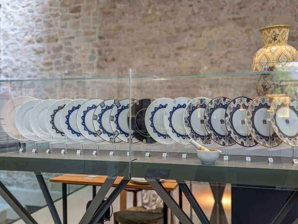 Different stages of painting porcelain plates in Limoges