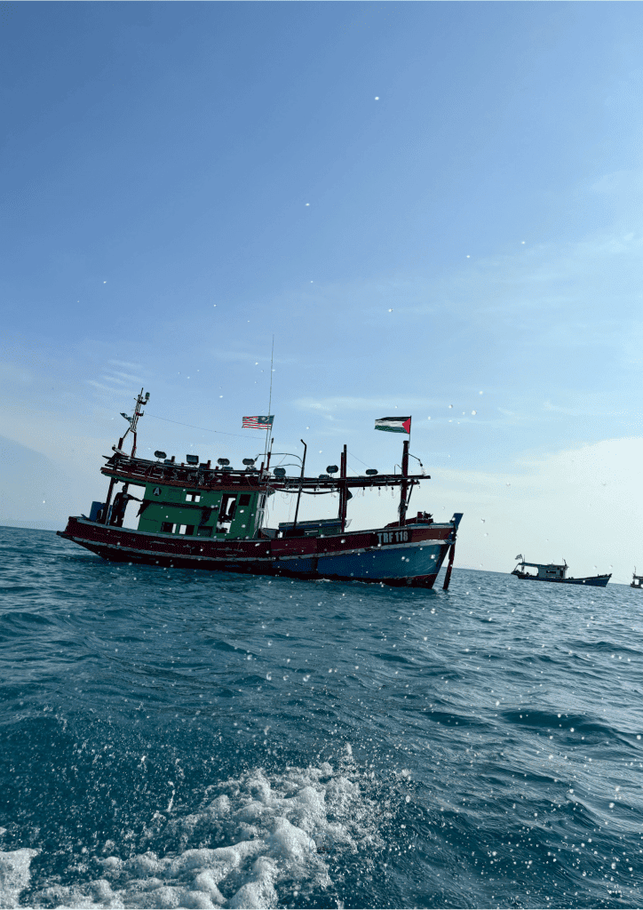 A boat flying a flag, perfect for exploring Malaysia's beautiful coastlines and vibrant culture.