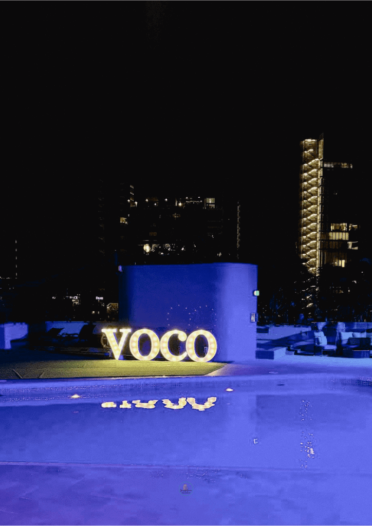 Voco Orchard logo overlooking pool