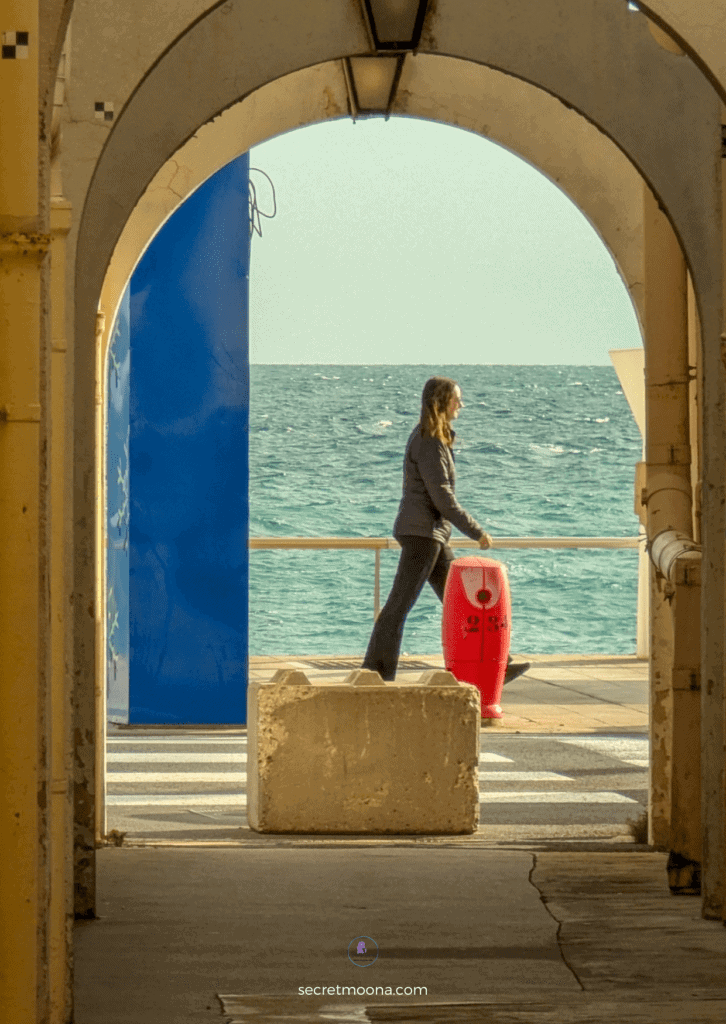 The Perfect One Day in Menton Itinerary: Discover Hidden Gems 32 A woman walks through an archway
