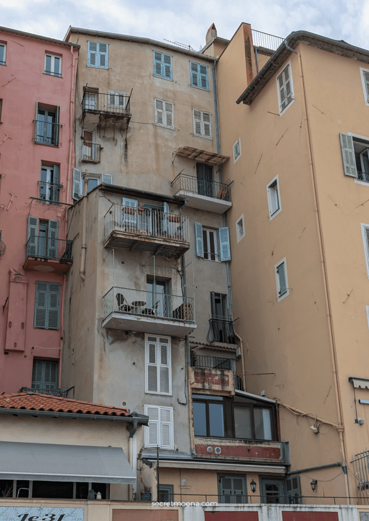 The Perfect One Day in Menton Itinerary: Discover Hidden Gems 8 A multi-story building featuring numerous balconies in Menton, France