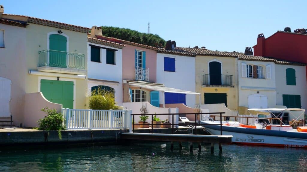 Port Grimaud: The Ultimate Guide to Provence's Little Venice 2 Colourful houses line the water in a harbour in Port Grimaud, France
