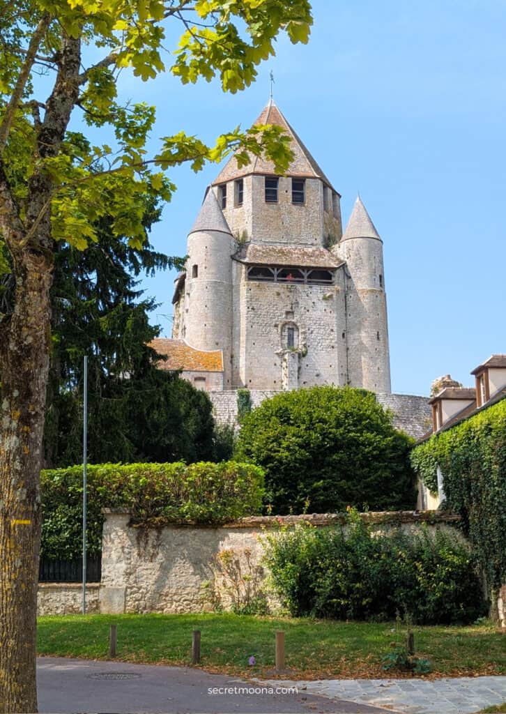 Historic Provins street with Tour César   a stone building and museum sign, sunny day, picturesque scenery.