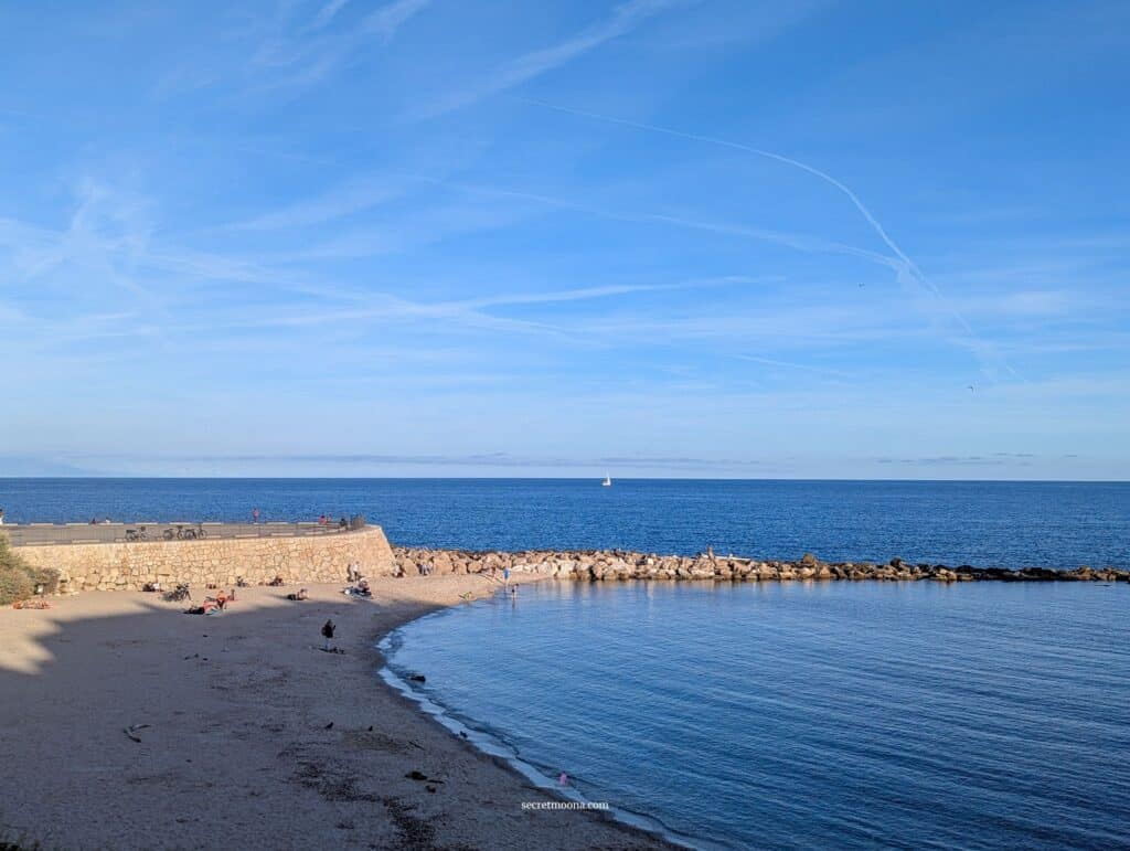 Curved sandy beach at Plage de la Gravette, near the Old Town in Antibes