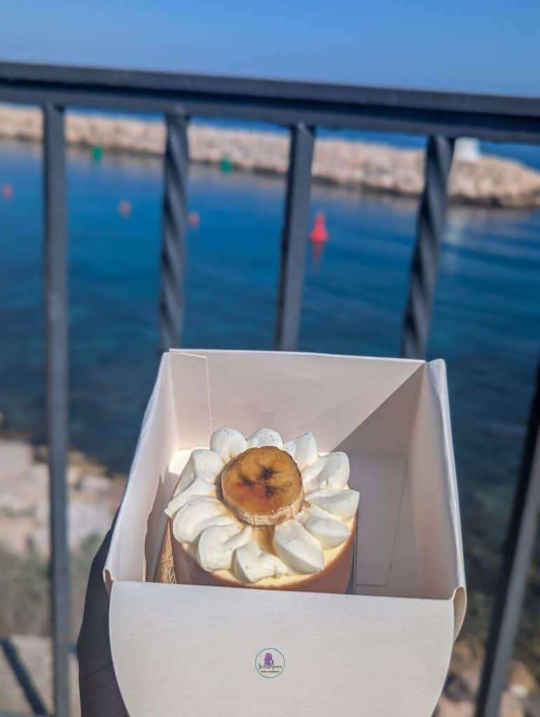 The Perfect 7-Day French Riviera Itinerary: Ultimate Côte d’Azur Travel Guide 20 Banana cake with whipped cream and banana slice, seaside view.