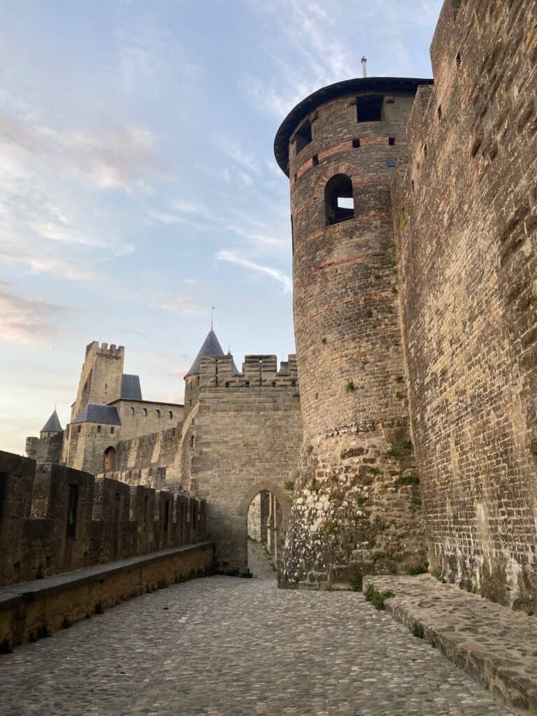 Cobblestone path beside the towers and ramparts of the medieval citadel of Carcassonne, one of the most beautiful towns in France