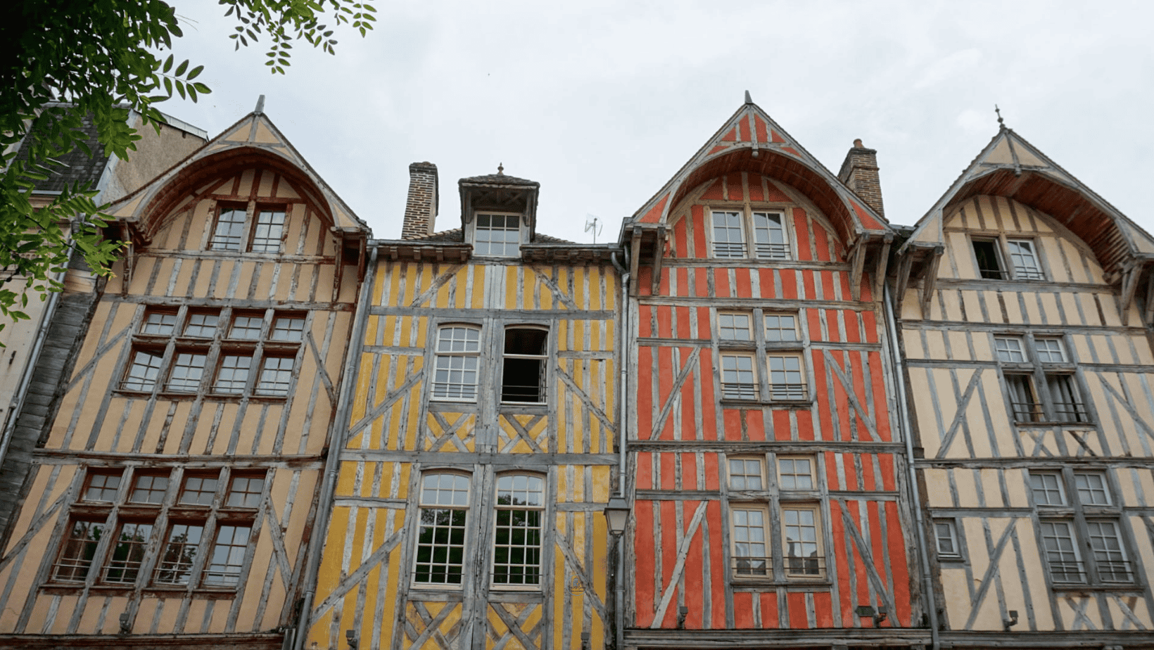 Row of pastel half-timbered houses along a pedestrian street in Troyes