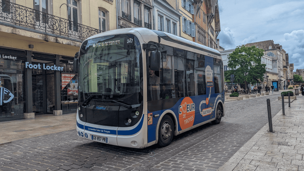Free electric shuttle bus driving through the historic centre of Troyes
