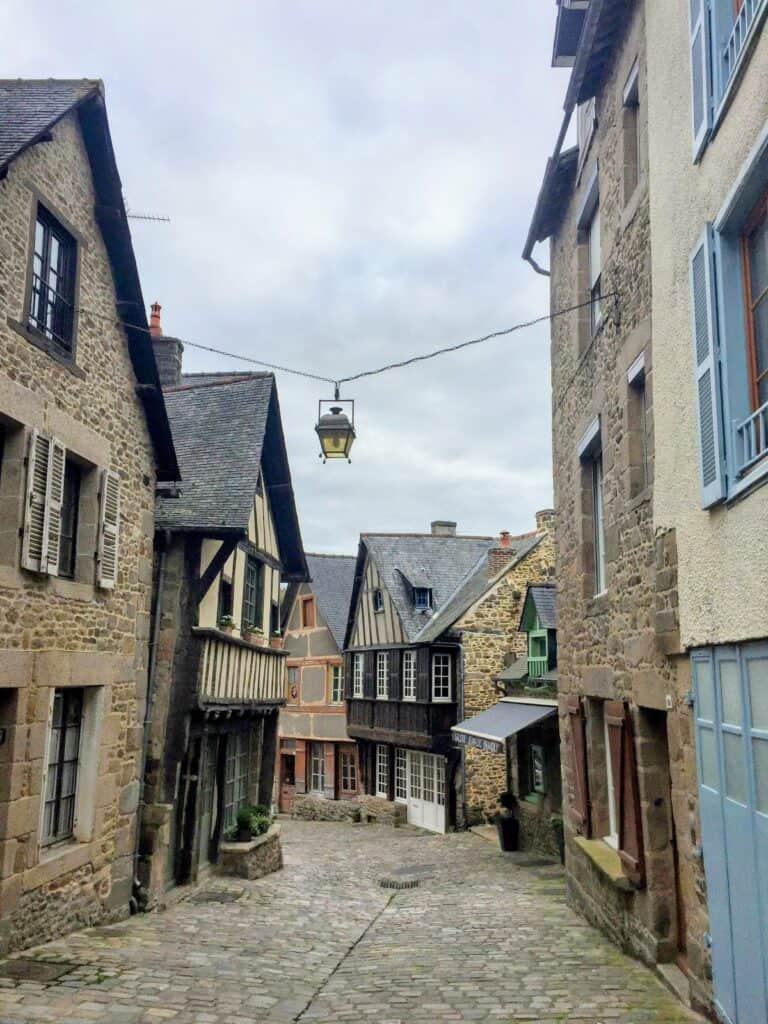 Beautiful Medieval Towns in France for History Lovers 4 Cobbled street lined with stone and half-timbered houses in the medieval town of Dinan