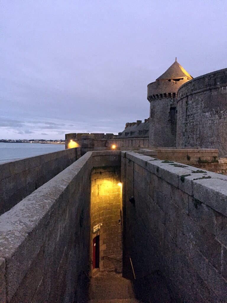 Beautiful Medieval Towns in France for History Lovers 14 Evening view of the stone ramparts and sea walls of Saint-Malo in Brittany