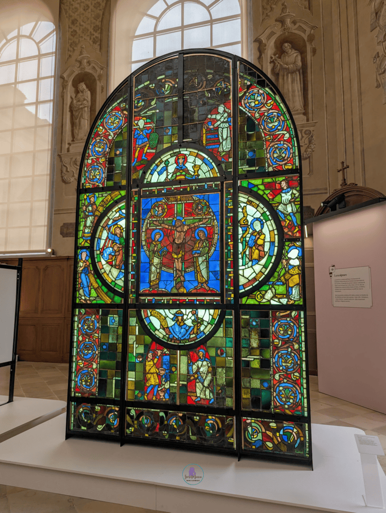 Large colourful stained glass window on display in Troyes, France