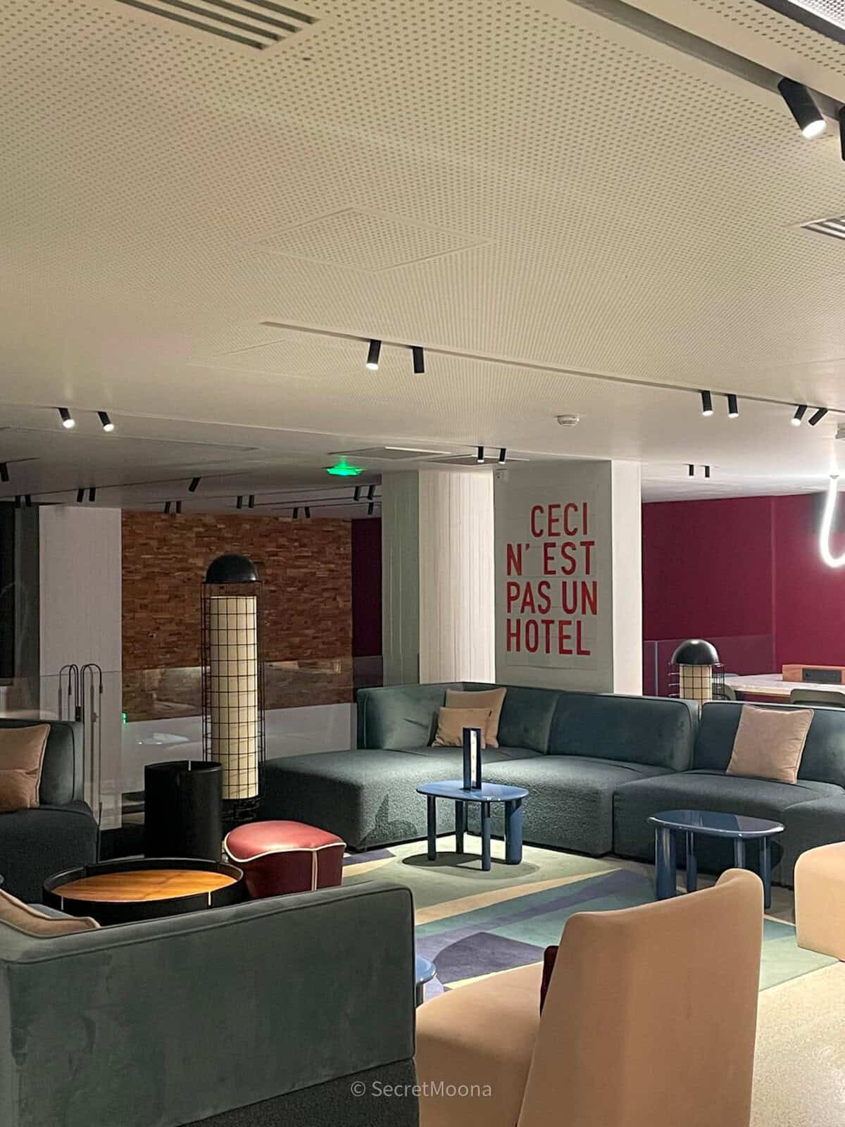 Contemporary lounge at TRIBE Paris Pantin with blue sofas and statement wall art