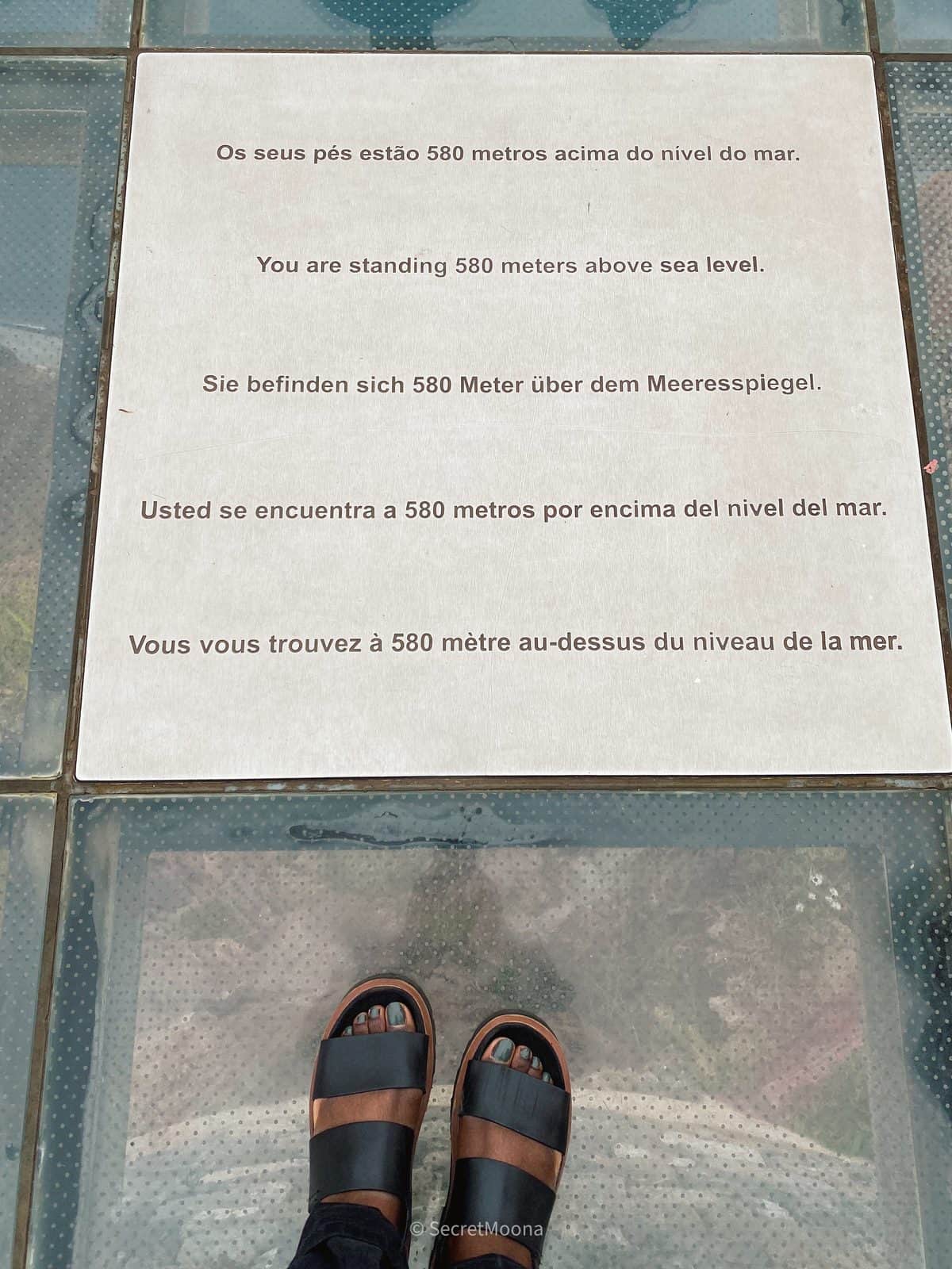 Looking down through the glass floor of the Cabo Girão skywalk to the sea 580 metres below