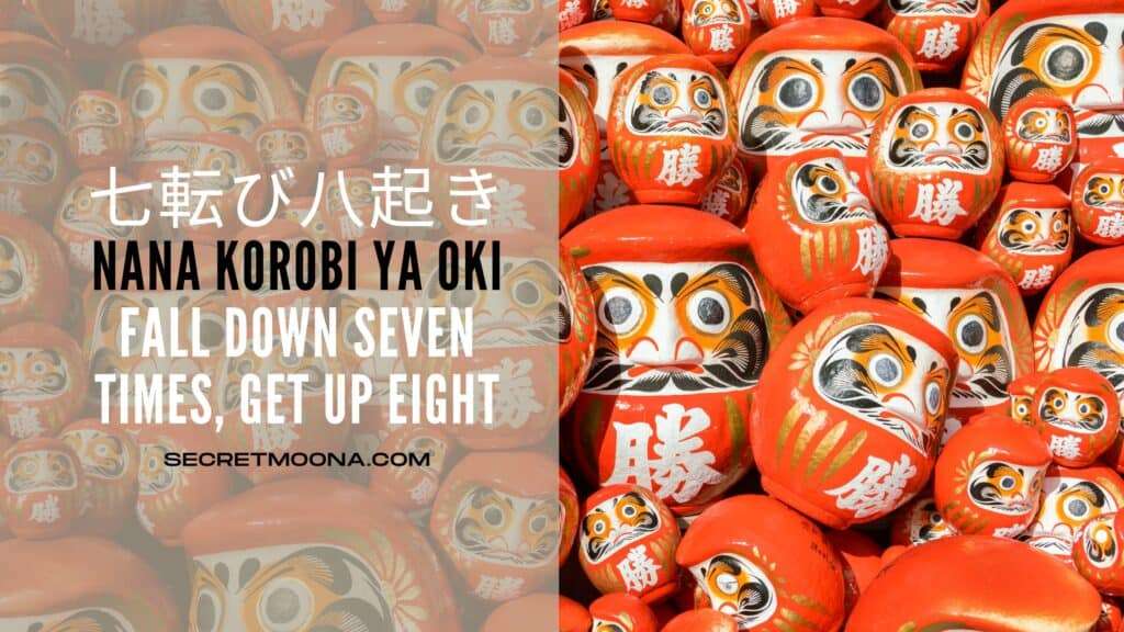 Nana korobi ya oki (七転び八起き), fall down seven times get up eight, shown beside a heap of red daruma dolls painted with the character for victory