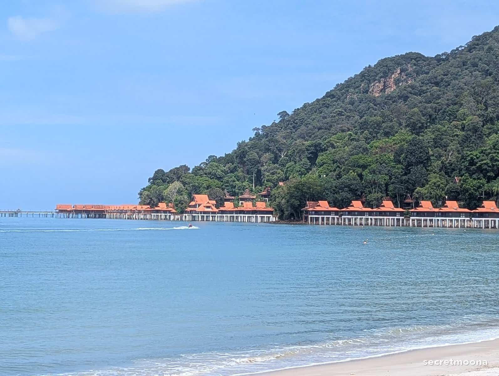 Looking along Burau Bay towards the rainforest headland and the orange-roofed chalets of the neighbouring Berjaya Langkawi Resort