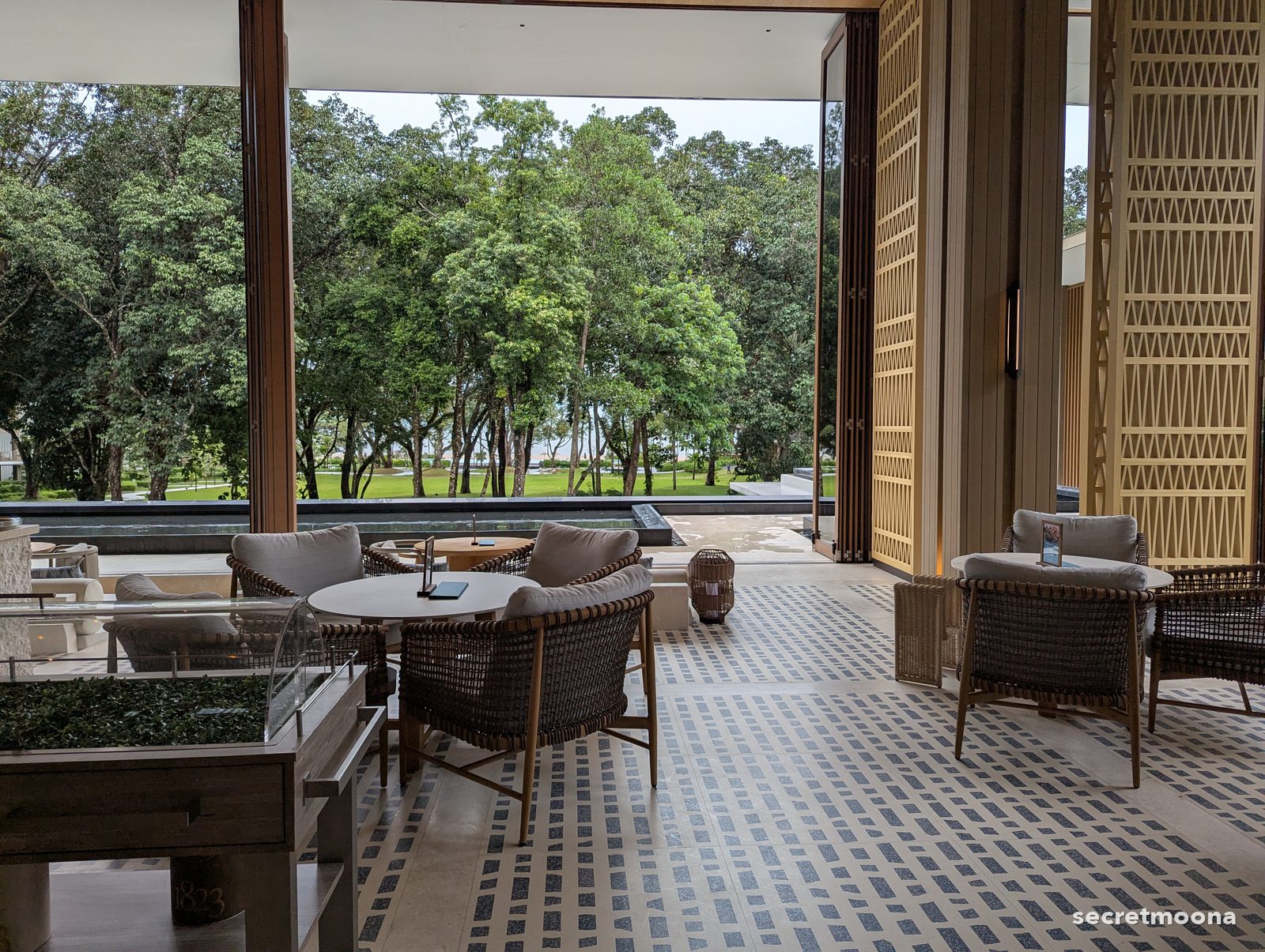 Rattan armchairs on a blue and white mosaic floor at Haliya Lounge, Hilton Burau Bay Langkawi