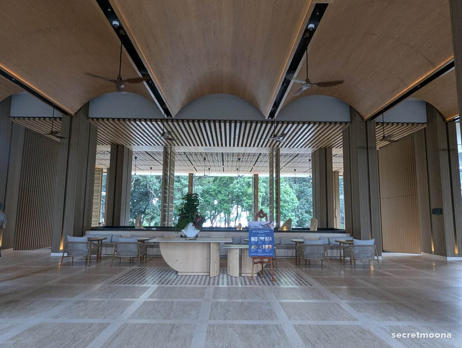 The barrel-vaulted timber lobby at Hilton Burau Bay Langkawi Resort, open at both ends to the gardens