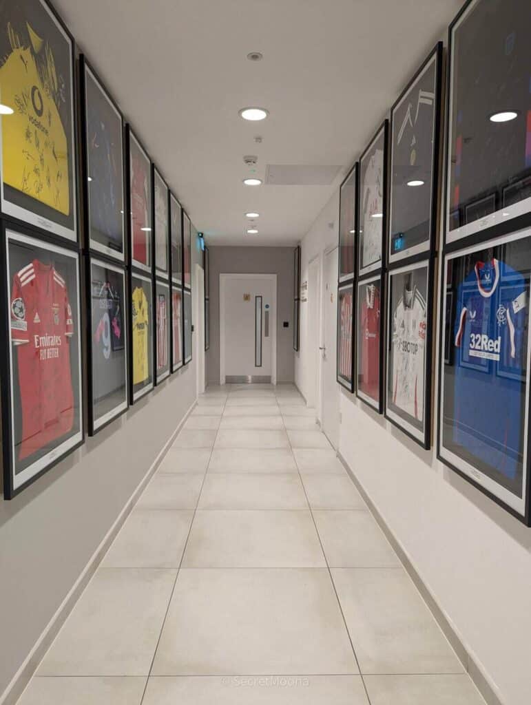 First-floor corridor at INNSiDE Liverpool lined with framed football shirts