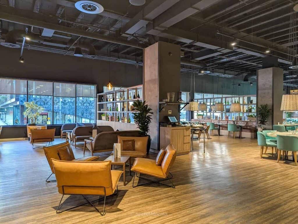 The INNSiDE Liverpool lobby lounge with tan leather armchairs and wooden floors