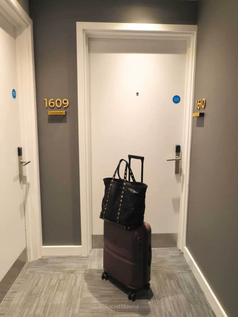 Hotel corridor outside room 1609 with a suitcase