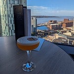 Review: INNSiDE by Meliá Liverpool - Stylish Hotel With a Sky Bar View A cocktail on a table overlooking the River Mersey from the 18th-floor Sky Bar