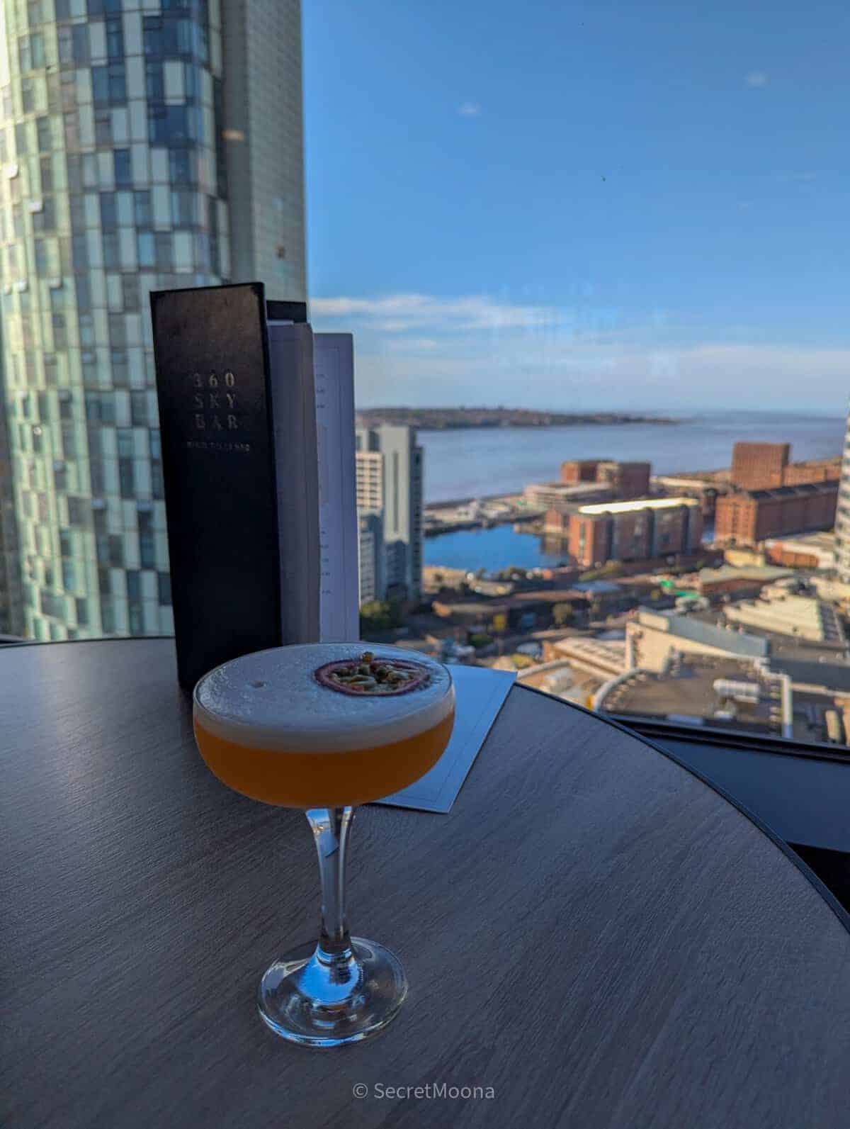 A cocktail on a table overlooking the River Mersey from the 18th-floor Sky Bar