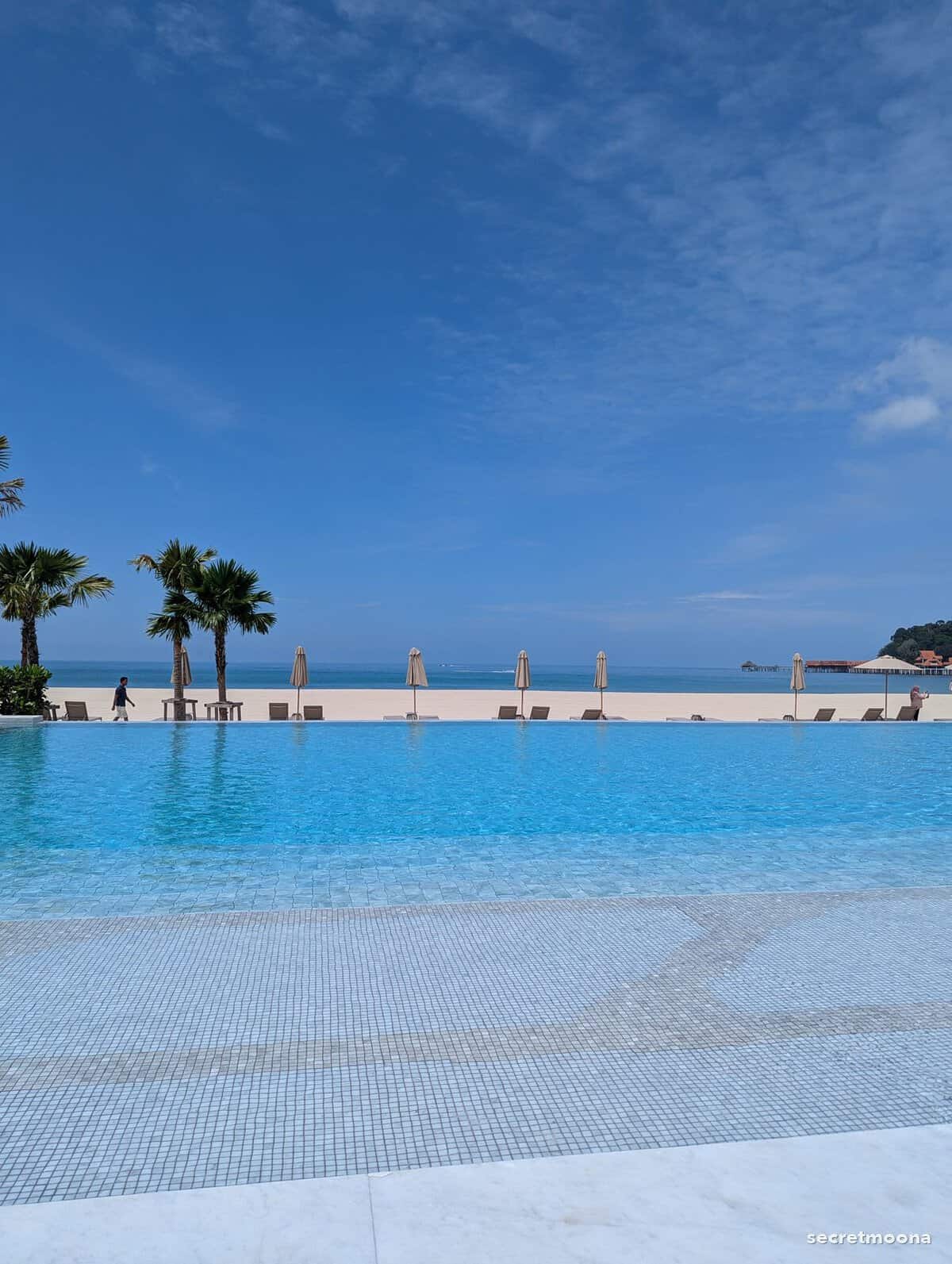 A palm-lined infinity pool facing the Andaman Sea in north-west Langkawi