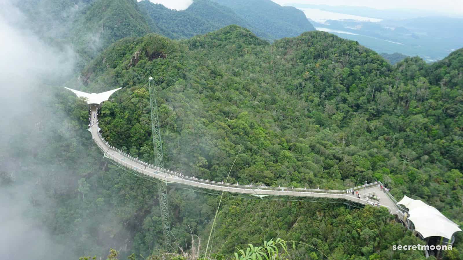 The curved Langkawi Sky Bridge suspended from a single pylon high above the rainforest