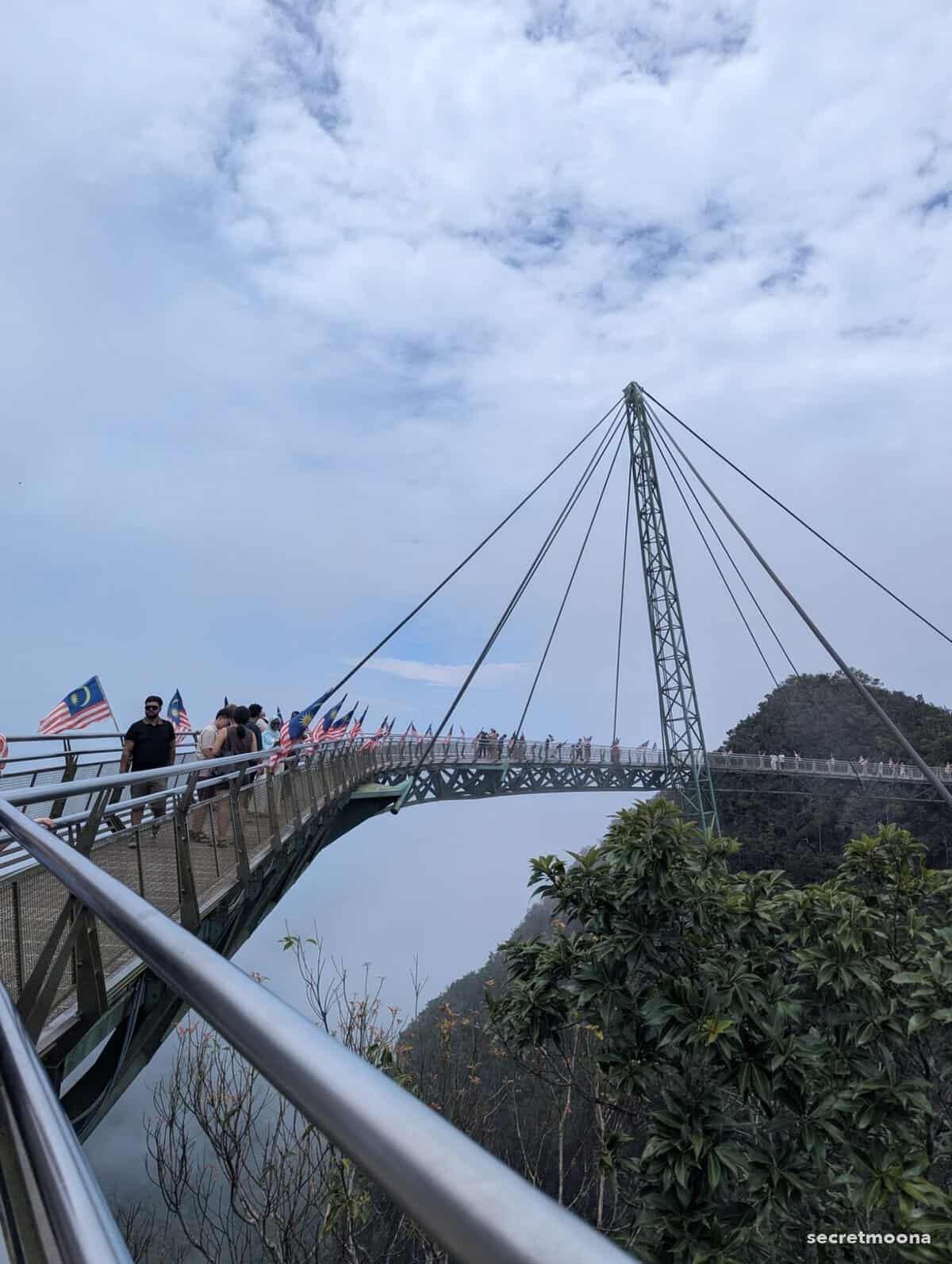Visitors crossing the Langkawi Sky Bridge, lined with Malaysian flags