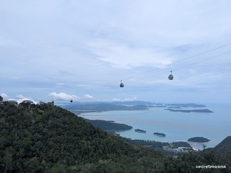 Green Panorama Langkawi SkyCab gondolas on the cable above the rainforest, with the bay and islands beyond