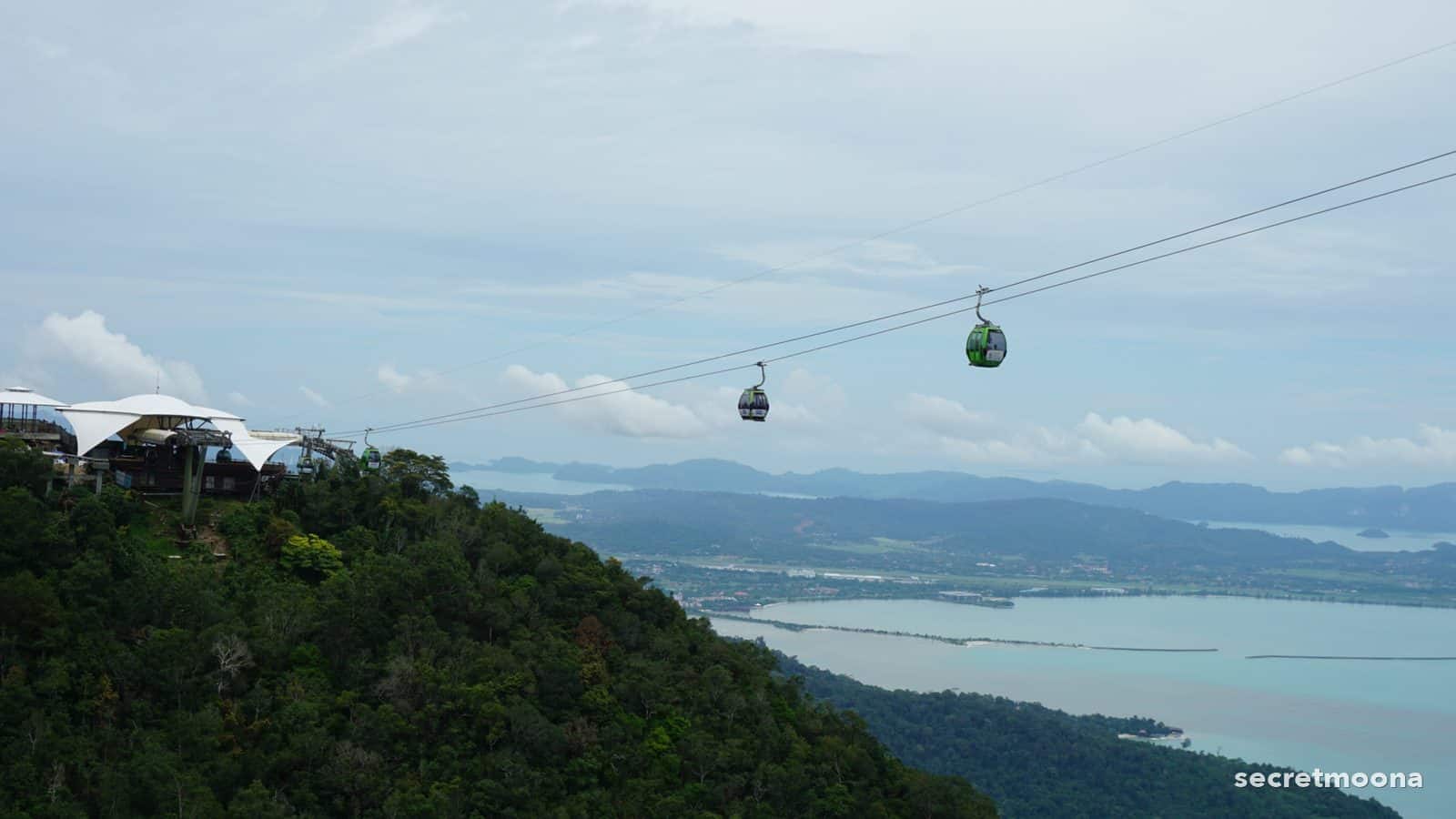 Panorama Langkawi SkyCab gondolas crossing above rainforest and the bay