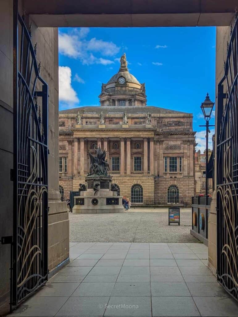 Liverpool Town Hall framed by ornate iron gates